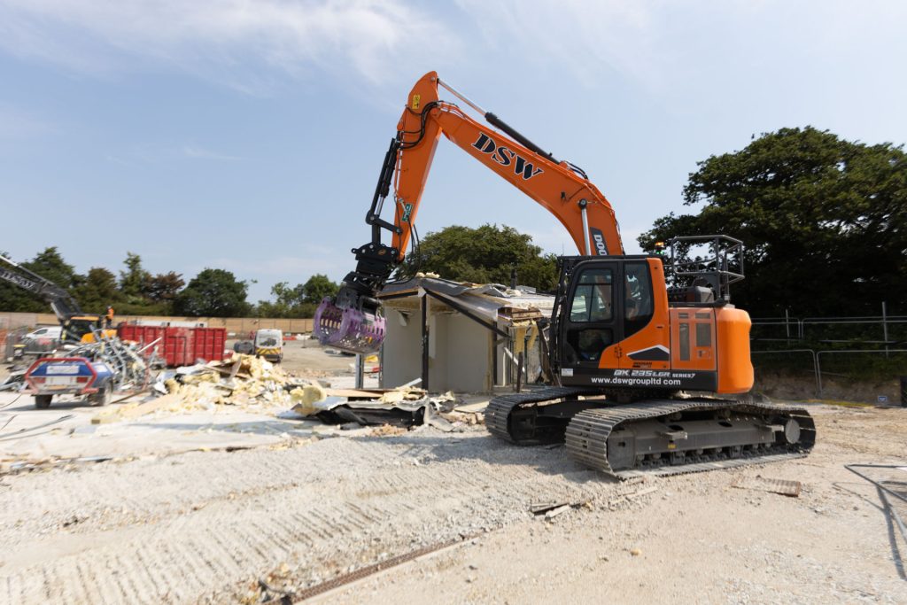 _33A7725 Various excavators in demolition site at a school - DSW