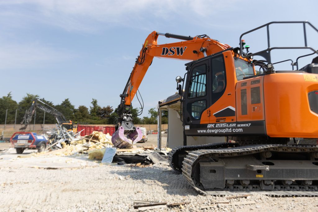 _33A7729 Various excavators in demolition site at a school - DSW